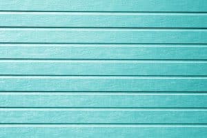 Plastic siding wall texture in cyan color.