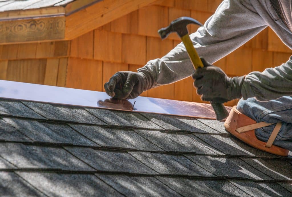 Man installing asphalt roof