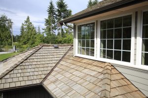 Shape And Texture Of A New Cedar Shingle Roof Close up looking down of New Cedar Shingle roof,gutters ,eaves and paned windows on a new home.