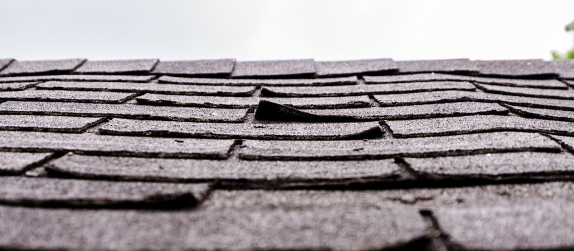 Close-up on damaged asphalt shingles