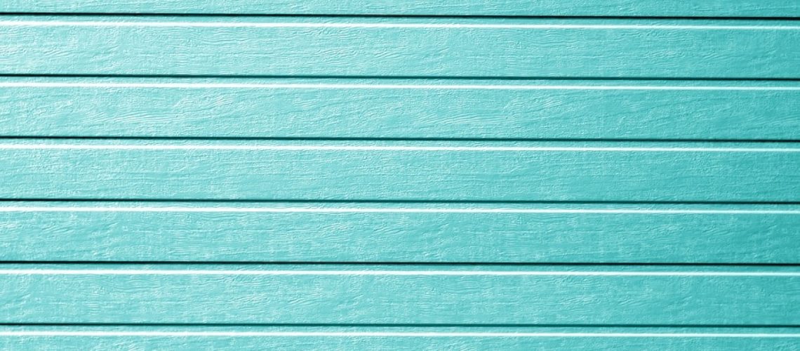 Plastic siding wall texture in cyan color. Abstract background and texture for design.