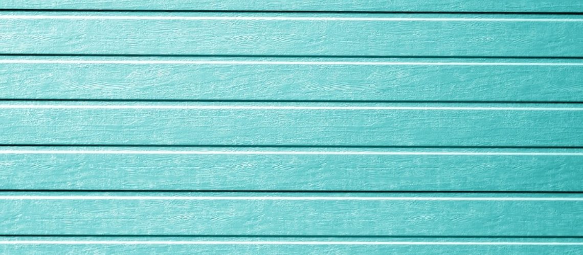 Plastic siding wall texture in cyan color.