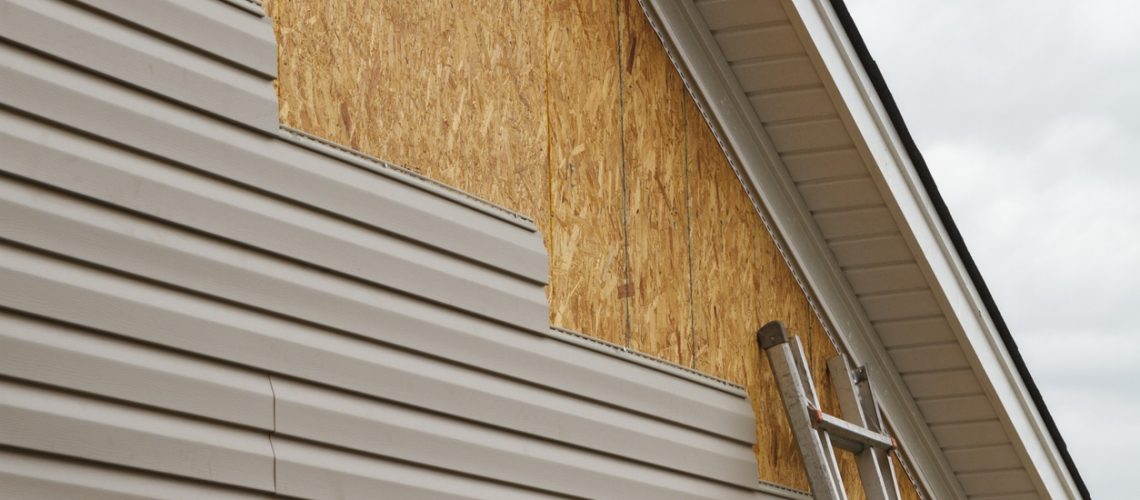 New siding being installed onto a home