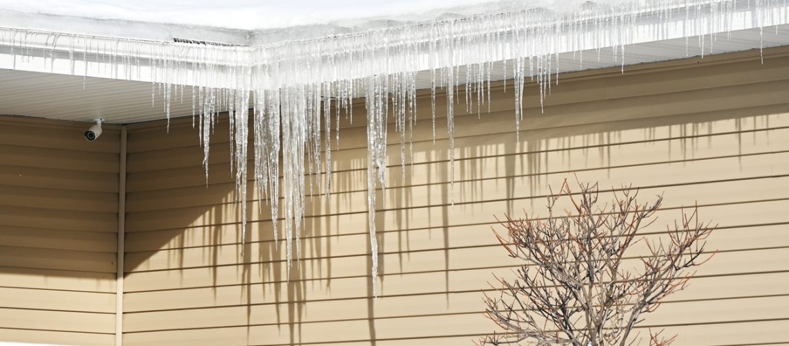 Row of icicles from the roof of the house.